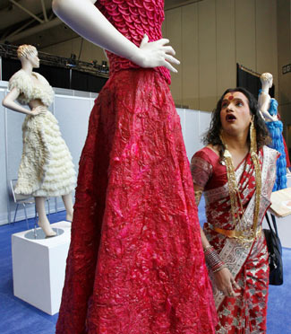 Laxmi Narayan Tripathi, a transvestite from India, looks at a dress made of condoms by Brazilian artist Adriana Bertini at the International AIDS conference in Toronto August 17, 2006. The exhibit aims to get people comfortable about condoms, especially those living in countries where the little piece of latex is considered taboo. [Reuters] 