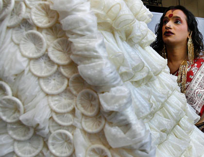 Laxmi Narayan Tripathi, a transvestite from India, looks at a dress made of condoms by Brazilian artist Adriana Bertini at the International AIDS conference in Toronto August 17, 2006. The exhibit aims to get people comfortable about condoms, especially those living in countries where the little piece of latex is considered taboo. [Reuters] 