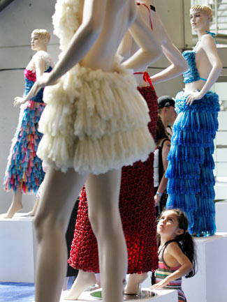 A girl looks at a dress made of condoms by Brazilian artist Adriana Bertini at the International AIDS Conference in Toronto August 17, 2006. The exhibit aims to get people comfortable about condoms, especially those living in countries where the little piece of latex is considered taboo. [Reuters] 