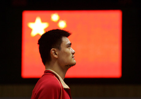 China's Yao Ming stands as the national anthems are played before the first round match against Slovenia at the world basketball championships in Sapporo, northern Japan August 24, 2006. 