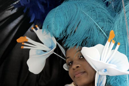 A carnival-goer in costume dances at the annual Notting Hill Carnival in London August 27, 2006. The carnival which began in 1964 and starts on Sunday is one of the world's largest street parties with thousands of people expected to attend over the Bank Holiday weekend. 