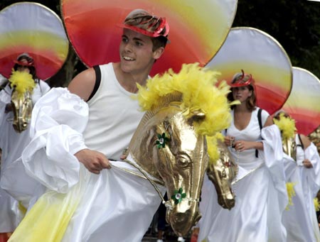 A carnival-goer in costume dances at the annual Notting Hill Carnival in London August 27, 2006. The carnival which began in 1964 and starts on Sunday is one of the world's largest street parties with thousands of people expected to attend over the Bank Holiday weekend.