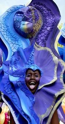 A carnival goer takes part in the Notting Hill Carnival in London, August 27, 2006. The carnival which began in 1964 and starts on Sunday is one of the world's largest street parties with thousands of people expected to attend over the Bank Holiday weekend. 