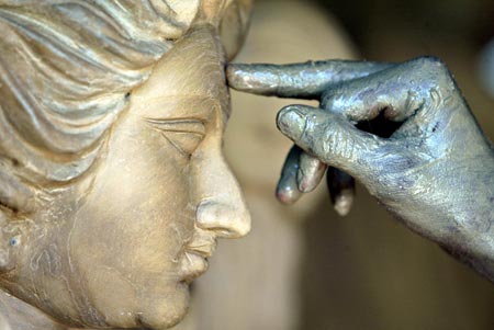 An artisan gives the finishing touches to the face of Hindu deity Durga at a workshop in the northeastern Indian city of Siliguri August 28, 2006. 