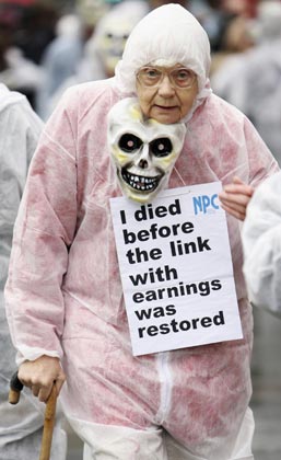 A pensioner marches as she takes part in a National Pensioners Convention lobby demonstration in central London October 25, 2006. The pensioners are calling to an immediate restoration of links with earnings, currently not due until 2010, to help pensioners who are currently struggling to pay bills. 