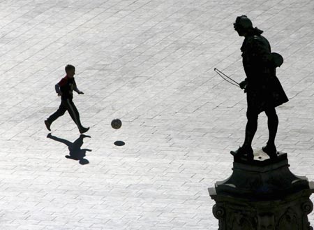 A boy plays football in Tartini's square in the seaside town of Piran, west Slovenia November 06, 2006. 