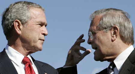 U.S. President George W. Bush (L) listens to U.S. Secretary of Defense Donald Rumsfeld at the United States Air Force Memorial dedication in Arlington, Virginia, October 14, 2006. 