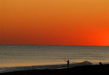 In this photo released by East Carolina University, Steven Smith enjoys fishing on the beach in Emerald Isle, N.C., Friday, Nov. 3, 2006. (AP Photo/East Carolina University, Marc J. Kawanishi) 