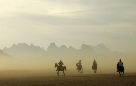 Horse riders from the Middle East compete in a 120 km (75 miles) International Endurance Race in the desert of Wadi Rum in southern Jordan November 14, 2006. 