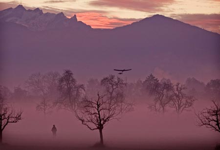 A man flies his model airplane on a autumn evening at dusk in Dornbirn some 20 kms (13 miles) from lake Constance November 14, 2006.