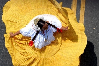 Panamanian woman dances wearing a Pollera, the typical Panamanian dress, in the independence day parade in Panama City, Panama, Friday, Nov. 10, 2006. 