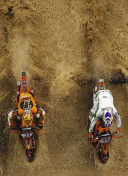 KTM riders Samuli Aro (L) of Finland and Xavier Galindo of Spain compete during the 'VIII Enduro Indoor of Barcelona' at the Sant Jordi Stadium in Barcelona, November 26, 2006.