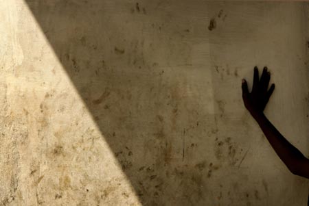 A boy leans against a wall in Senegal's capital Dakar, December 5, 2006. 