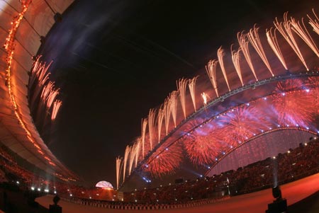 Fireworks explode over Khalifa Stadium during the closing ceremony for the 15th Asian Games in Doha December 15, 2006.