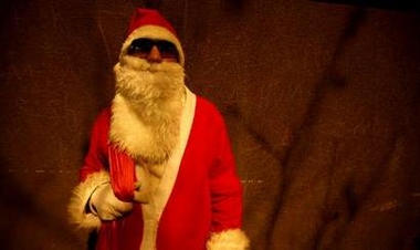 An Iranian Christian man dressed as Santa Claus stands outside the church of the Italian embassy during a Christmas Eve mass in Tehran December 24, 2006.