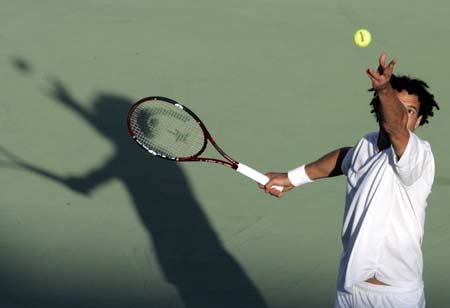 Younes El-Aynaoui of Morocco serves the ball to Thomas Johansson of Sweden during the Qatar Open tennis tournament in Doha,January 2, 2007. 