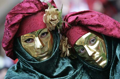 Revellers wear masks during a Carnival parade in Oviedo, northern Spain, February 24, 2007. 