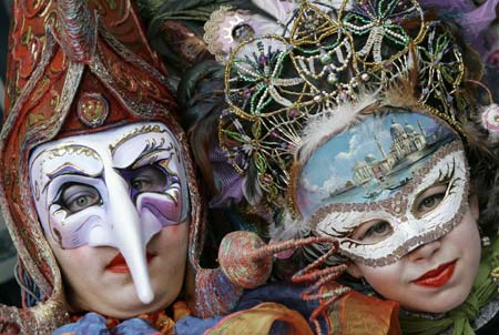 Revellers wear masks during a Carnival parade in Oviedo, northern Spain, February 24, 2007. 