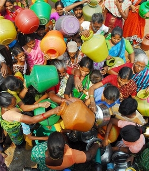 Women struggle through a crowd to reach a mobile water tanker in a slum area in Hyderabad, India, Wednesday, March 21, 2007. 'Coping with Water Scarcity' is the theme for World Water Day 2007, which is celebrated each year on March 22. (AP Photo/Mahesh Kumar A) 