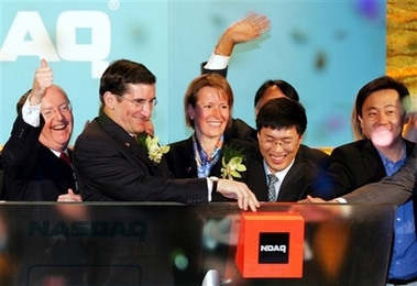 U.S. Ambassador to China Clark Randt, left, and NASDAQ President and CEO Bob Greifeld, second left, and representatives of Chinese companies listed on the NASDAQ, ring the opening bell of the exchange, in Beijing Tuesday April 3, 2007. The ceremony, the first time a U.S. exchange has opened its market from China, was broadcast live in New York's Times Square.