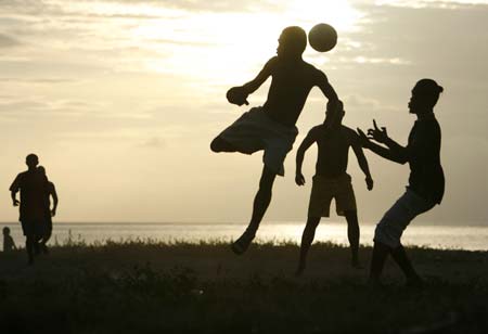 East Timorese youths play football at a beach in Dili, May 7, 2007. 