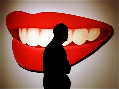 Mouth #2 : A possible buyer walks past a sculpture titled 