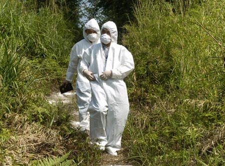 Chinese health officials inspect a disinfected area at Shijiping village in Taojiang County, Central China's Hunan province, May 20, 2007. Bird flu has killed 11,172 poultry in Shijiping, Xinhua said Saturday. A further 52,800 birds were also slaughtered to prevent any spread of the disease. Agriculture officials say that the outbreak had brought under control. [Xinhua]