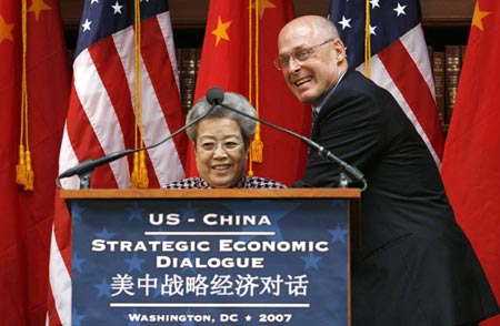 U.S. Treasury Secretary Henry Paulson leans over to shake hands with China's Vice Premier Wu Yi after they gave statements at the conclusion of the U.S.-China Strategic Economic Dialogue in Washington May 23, 2007. 