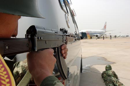 Chinese special policemen prepare to storm an aircraft during an anti-hijacking drill at an airport in Hohhot, North China's Inner Mongolia Autonomous Region, May 31, 2007. China is looking to establish an anti-terrorism legal framework and authorities are busy drafting a law to better combat terror threats, China Daily reported.