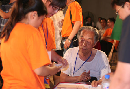 A residents' representative monitors the counting after a voting on the housing demolition and compensation policy at Jiuxianqiao sub-district in Chaoyang District of Beijing, June 9, 2007. Some 3,711 families, about 57% of the 5,473 families, cast their votes on Saturday, with 2,451 votes for and 1,228 votes against the demolition and compensation plan. Thirty-two votes were invalid. 