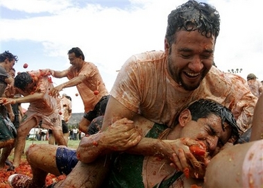 Participants throw tomatoes at each other during the third annual tomato fight called 'tomatina' in Sutamarchan, 115 km, 71 miles northeast of Bogota, Sunday, June 10, 2007. 