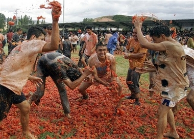 Participants throw tomatoes at each other during the third annual tomato fight called 'tomatina' in Sutamarchan, 115 km, 71 miles northeast of Bogota, Sunday, June 10, 2007.