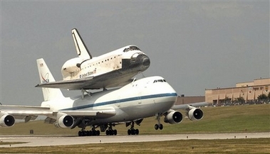 This photo provided by the U.S. Air Force shows a jumbo jet carrying the space shuttle Atlantis landing at Offutt Air Force Base, in Neb., Sunday, July 1, 2007. The jet made a planned stop at Offutt Air Force Base near Omaha, Neb., Sunday, June 1, 2007, for refueling and to check the connection between it and the shuttle. NASA officials said the shuttle will not take off until Monday morning at the earliest.(AP Photo/U.S. Air Force, Charles J. Haymond) 