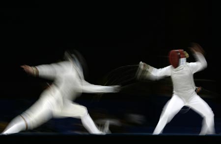 Mariana Gonzalez (R) of Venezuela fences against Hanna Thompson of U.S. during their women's individual foil fencing final match at the Pan American Games in Rio de Janiero July 15, 2007. Gonzalez won the gold medal and Thompson won the silver medal. 