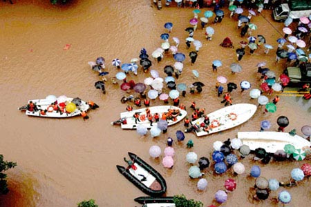 A general view shows Chinese soldiers evacuate residents stranded in flood after heavy rain in Bishan, Southwest Chna's Chongqing Municipality, July 17, 2007.