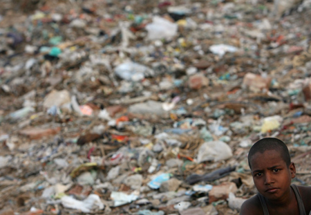 Indian children work in garbage dump