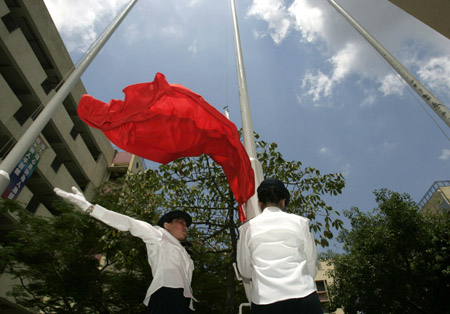 Students rehearse raising national flag