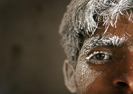 Abid, a labourer covered in salt powder, poses for a photograph while cutting rock salt for decoration pieces in Khewra, Pakistan on August 4, 2007. Khewra, best know for its salt range and mines, is located nearly 170 kilometers (106 miles) south of Islamabad. The Khewra Salt Mines are said to be the second largest salt mine in the world. Labourers in the town make an average of 250 rupees ($5) a day.