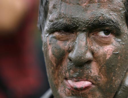 A reveller covered in mud is pictured during Sziget Music Festival on an island in Danube, Budapest August 12, 2007. The annual non-stop festival lasts for a week. 