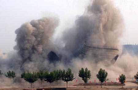 A cooling tower at the Datang Weihe Power Generation Company is imploded in Xianyang, North China's Shaanxi Province, August 15, 2007. China shut down small thermal power plants with an installed capacity totaling 6.95 million kilowatts in the first half of the year, completing about 70 percent of the pre-set goal in this regard in 2007, Xinhua News Agency reported. [Xinhua]