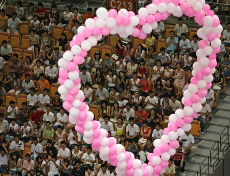 Single Chinese men and women take part in a mass matchmaking event in a stadium in Wuhan, Central China's Hubei Province, August 19, 2007. A variety of activities were organized to celebrate Chinese Valentine's Day, which falls on the seventh day of the seventh month on the lunar calendar.[Xinhua]