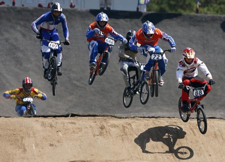 Competitors ride over the course during the UCI BMX Supercross World Cup at Laoshan Bicycle Moto Cross (BMX) venue in Beijing August 21, 2007.[Xinhua]