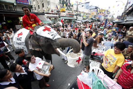 Thai elephants help collect money for Haiti