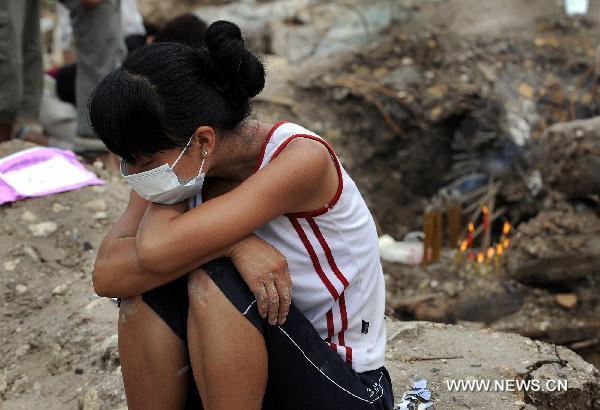 Residents mourn the deceased in mudslide-hit Zhouqu