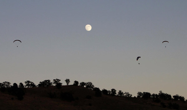 Paragliders sail above moon