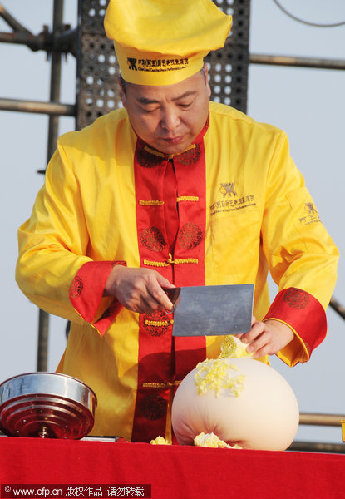 Pastry master blows dough balloon