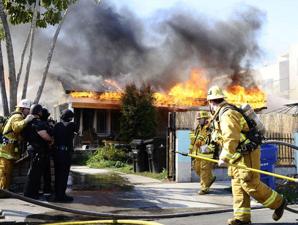 Los Angeles firefighters battle a house fire