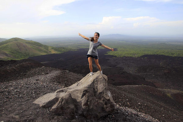 Tourists surf Cerro Negro volcano in Nicaragua