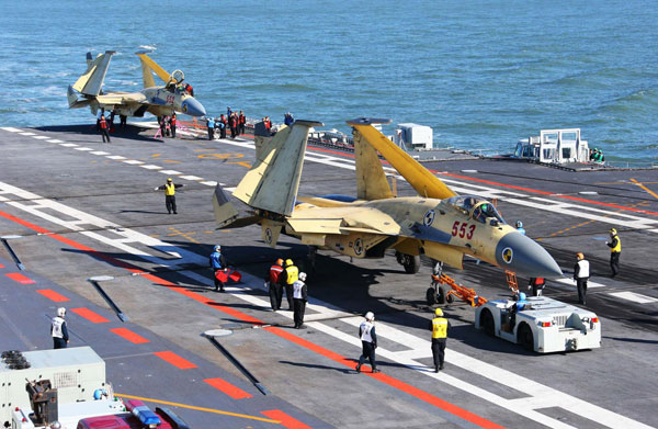 China conducts flight landing on aircraft carrier