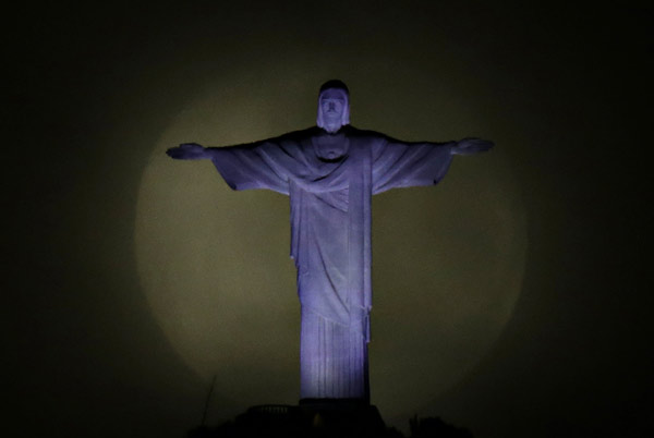 Big moon pictured with Christ the Redeemer statue